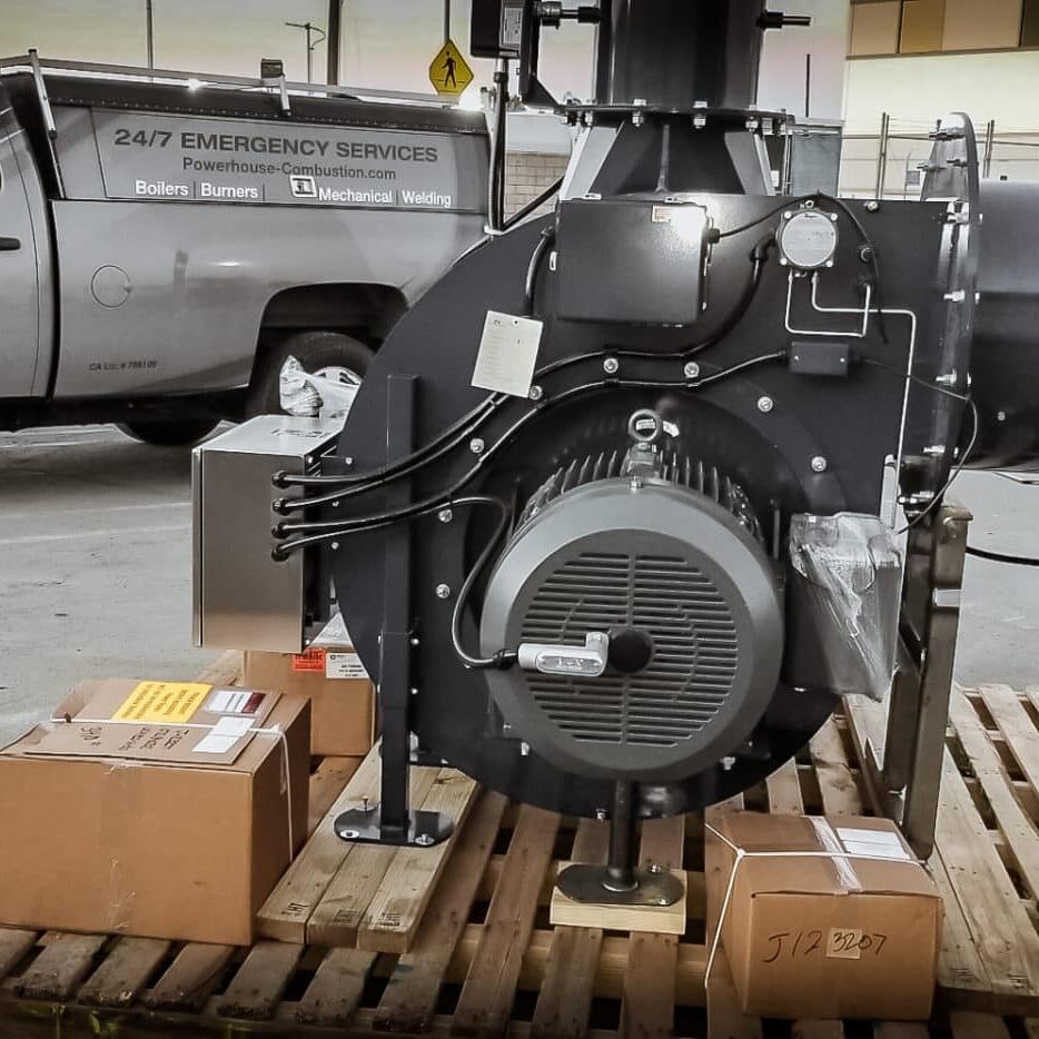 A large industrial diesel engine on display in a warehouse setting.